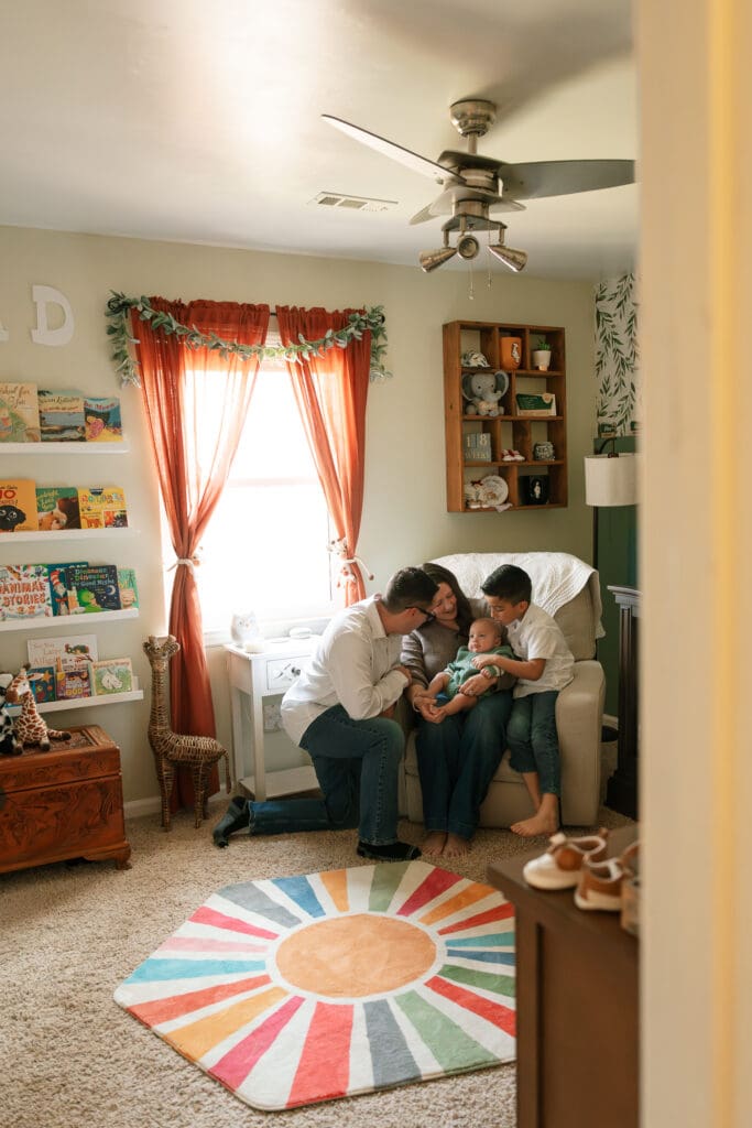 Family snuggling on couch during in-home lifestyle photography session in Chattanooga TN
