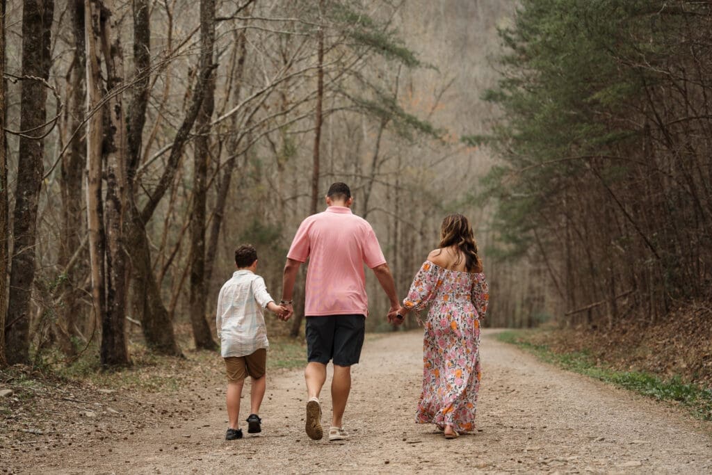 family walking down trail during family photo session
