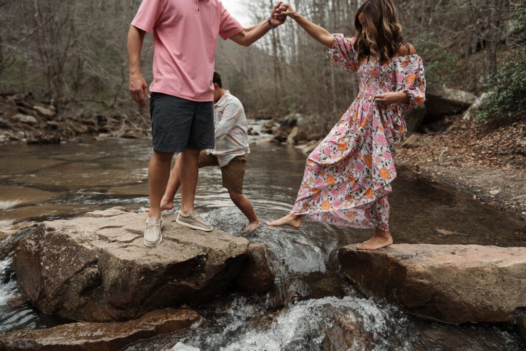 family playing in creek during family photo session