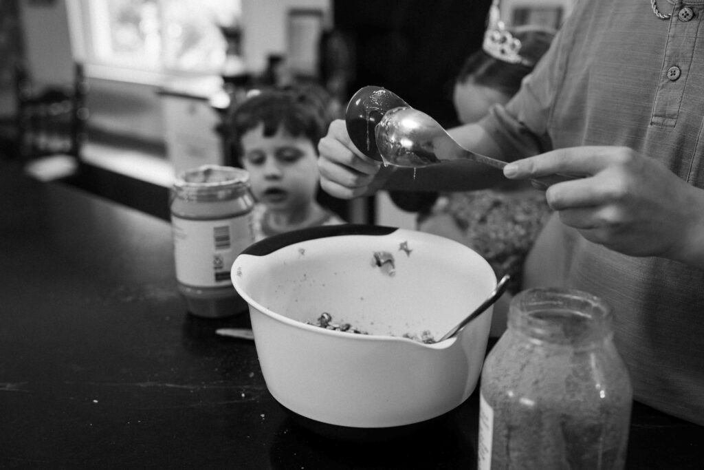 black and white image of kids baking in kitchen
