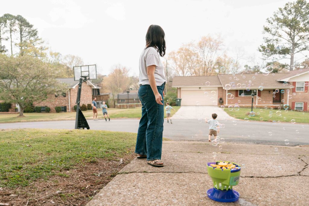 mom looking at kids playing outside