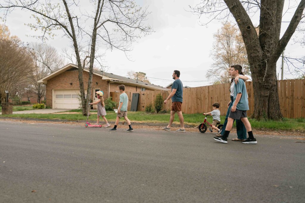 family taking a walk down the street
