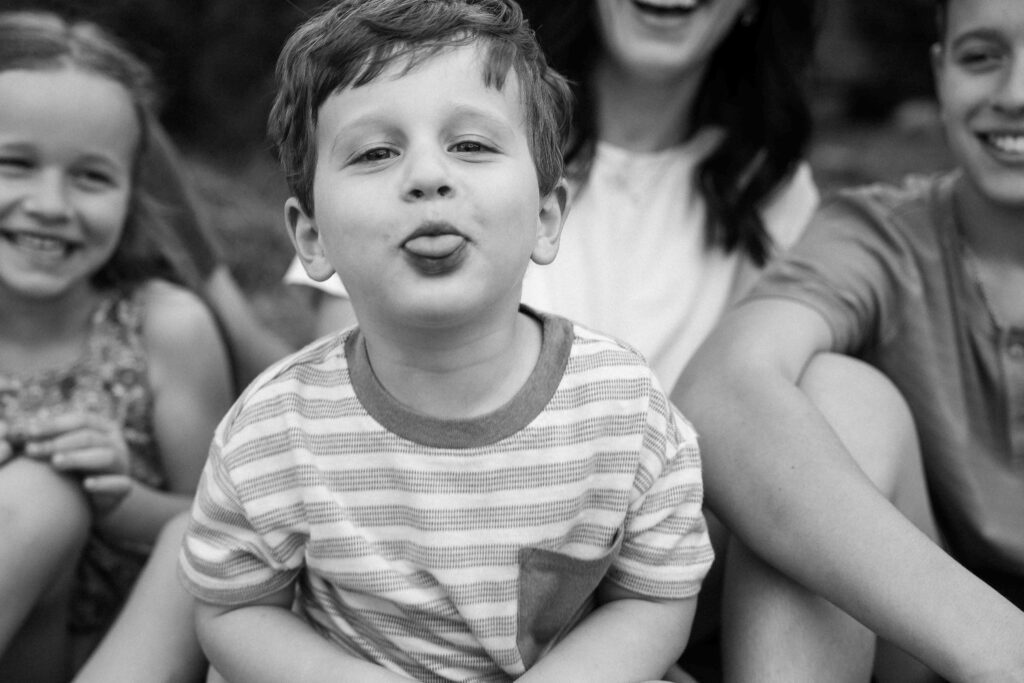 little boy sticking tongue out at camera
