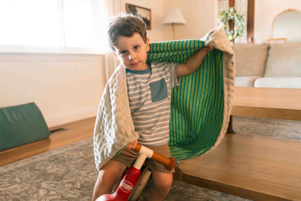 little boy playing with toys inside home