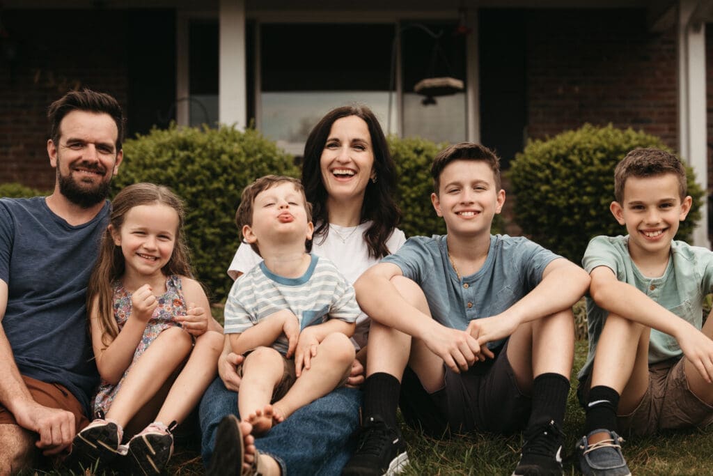 family sitting in front yard