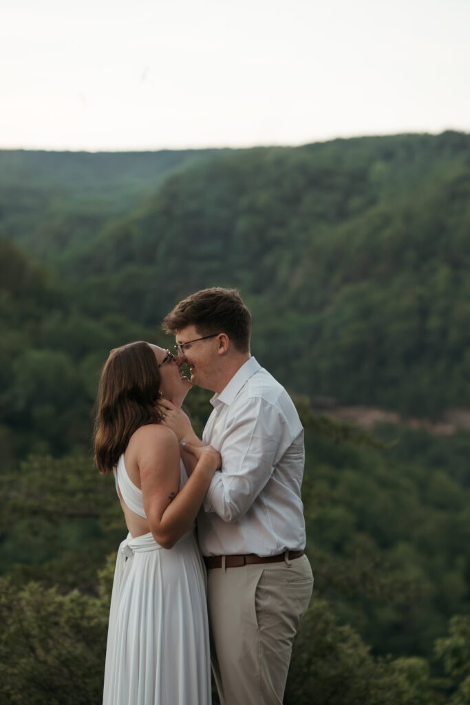 Couple laughing and sharing an intimate moment on a mountain overlook during their Tennessee elopement