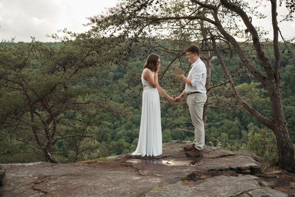 Couple exchanging vows on a mountain overlook during their Tennessee elopement