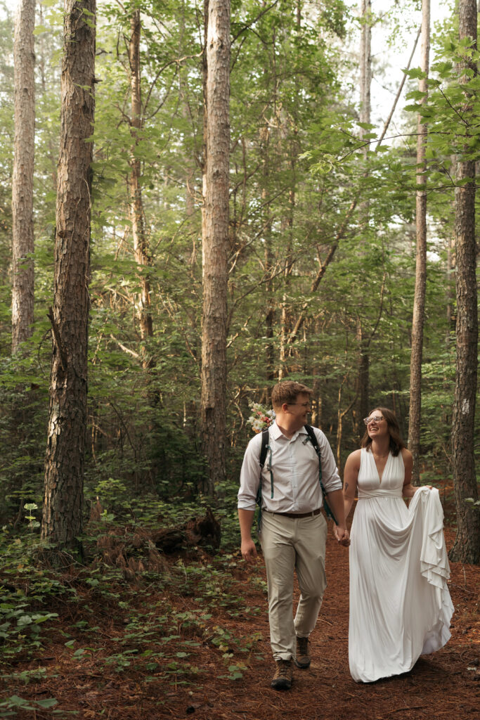 Couple walking hand in hand through the forest on their Tennessee elopement day