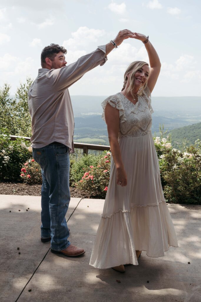 Groom twirling his bride during their first look overlooking Sequatchie Valley in Chattanooga